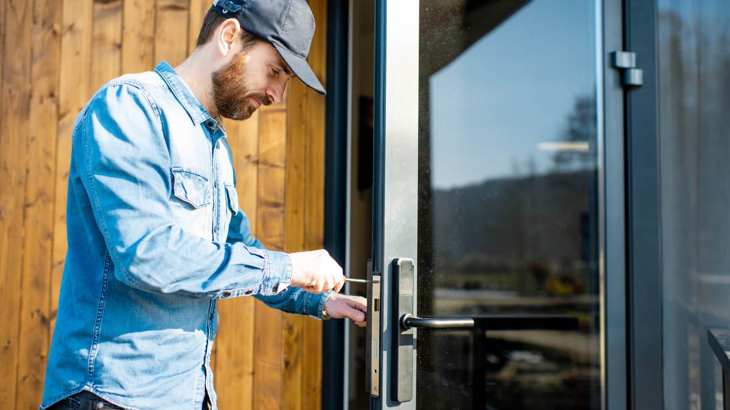 man repairs home door